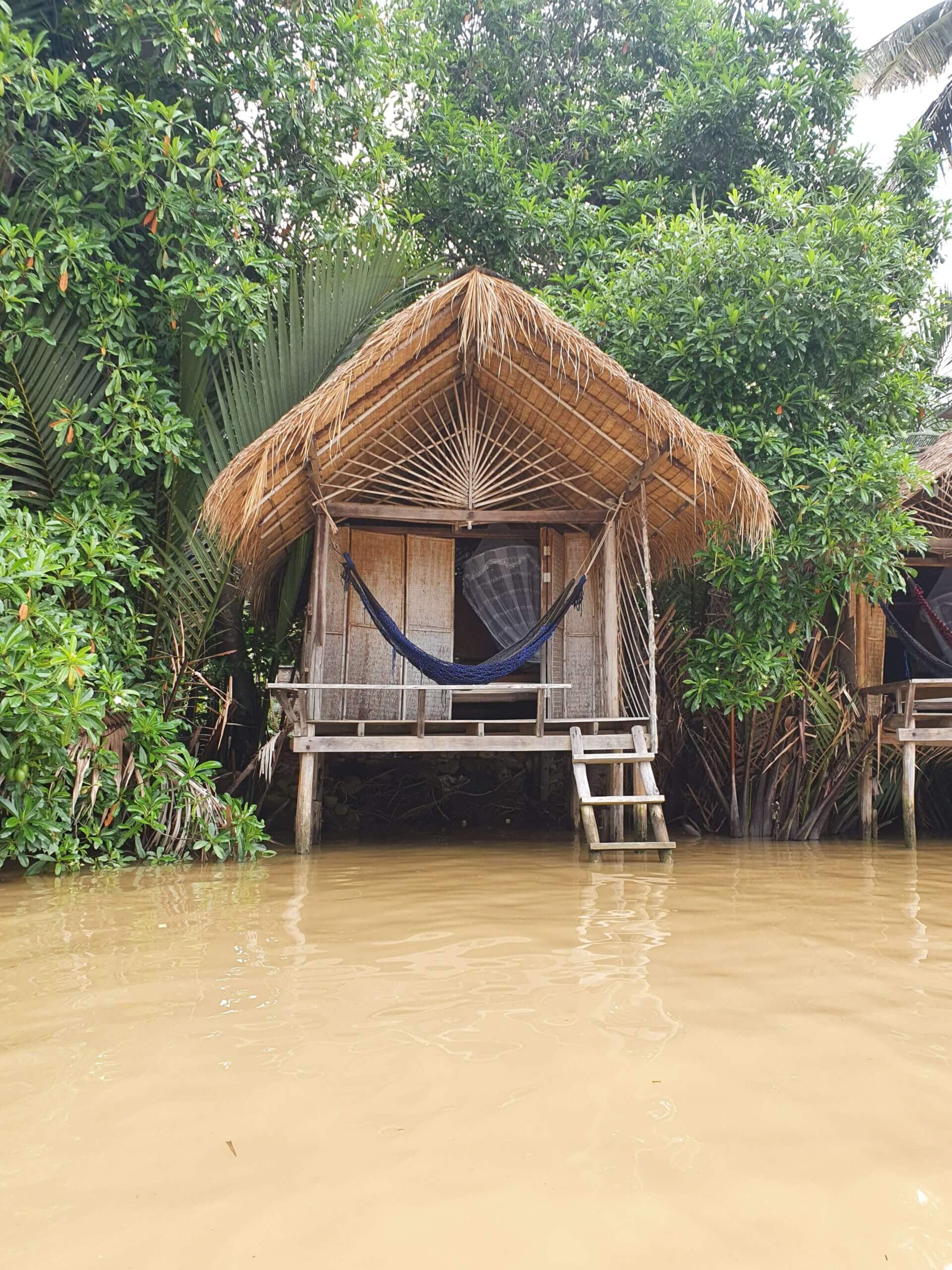A bamboo hut on a riverbank