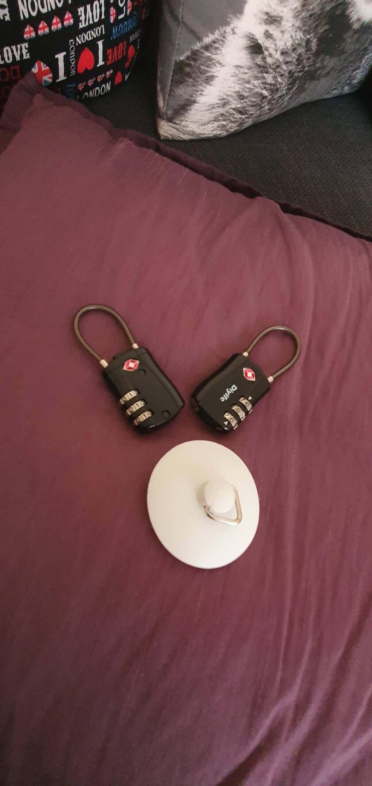Two luggage locks and a sink stopper