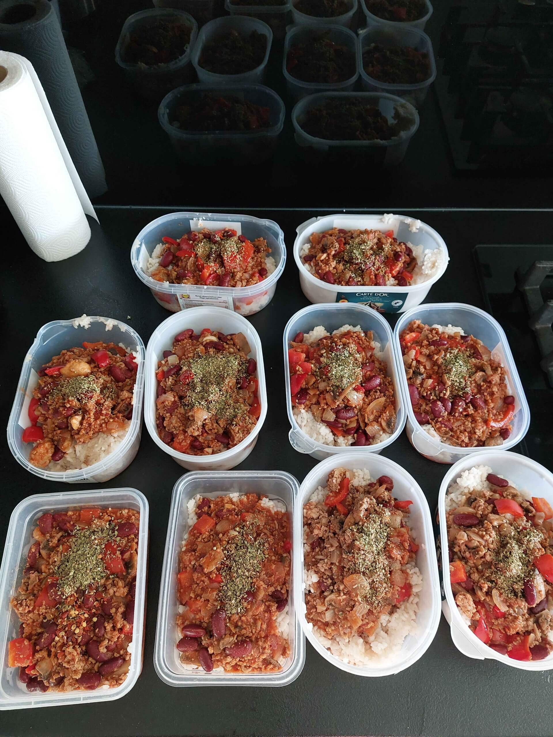 Plastic tubs full of homecooked chili