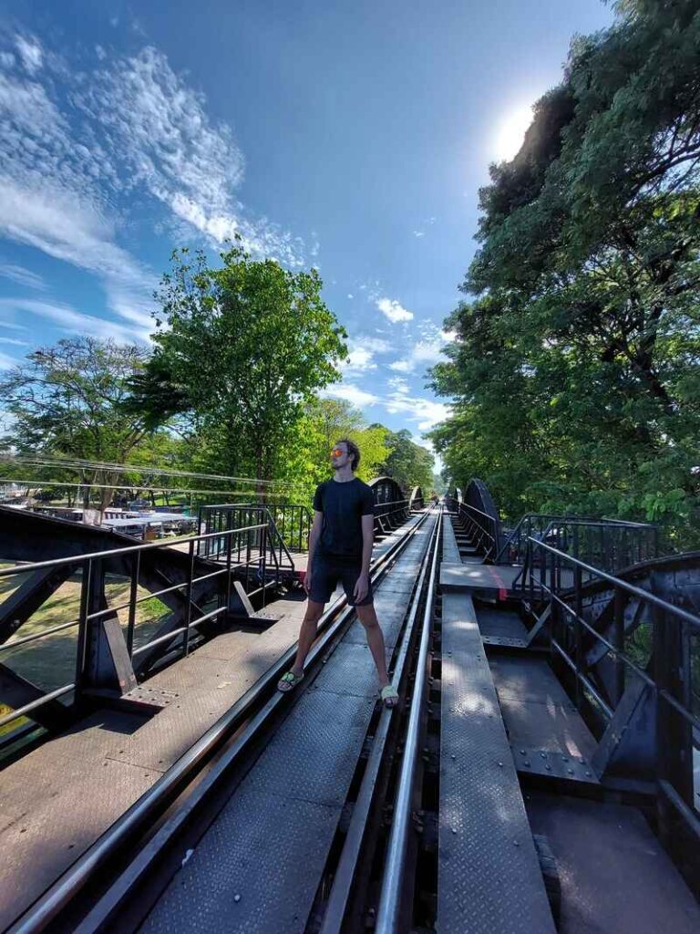 Daniel standing on train tracks in Kanchanaburi, Thailand
