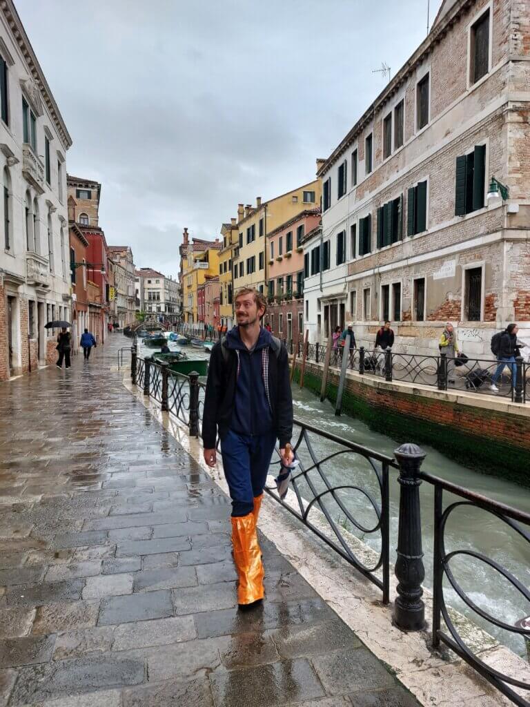 Daniel walking along the canal in Venice. It's rainy