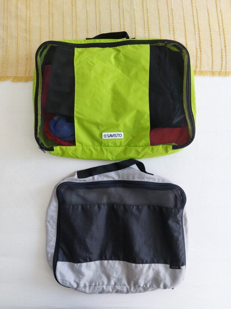 Two packing cubes, one with mesh on both sides, one with just a small mesh area at the top to compare the different options available.