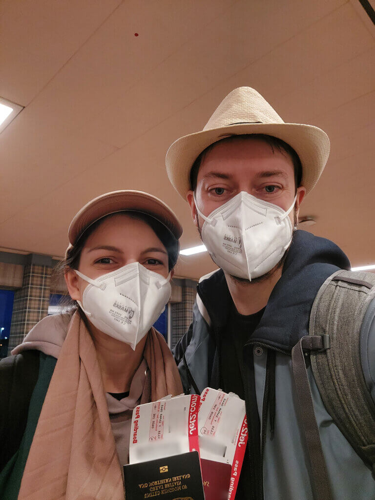 Mirka and Daniel holding passports and boarding passes