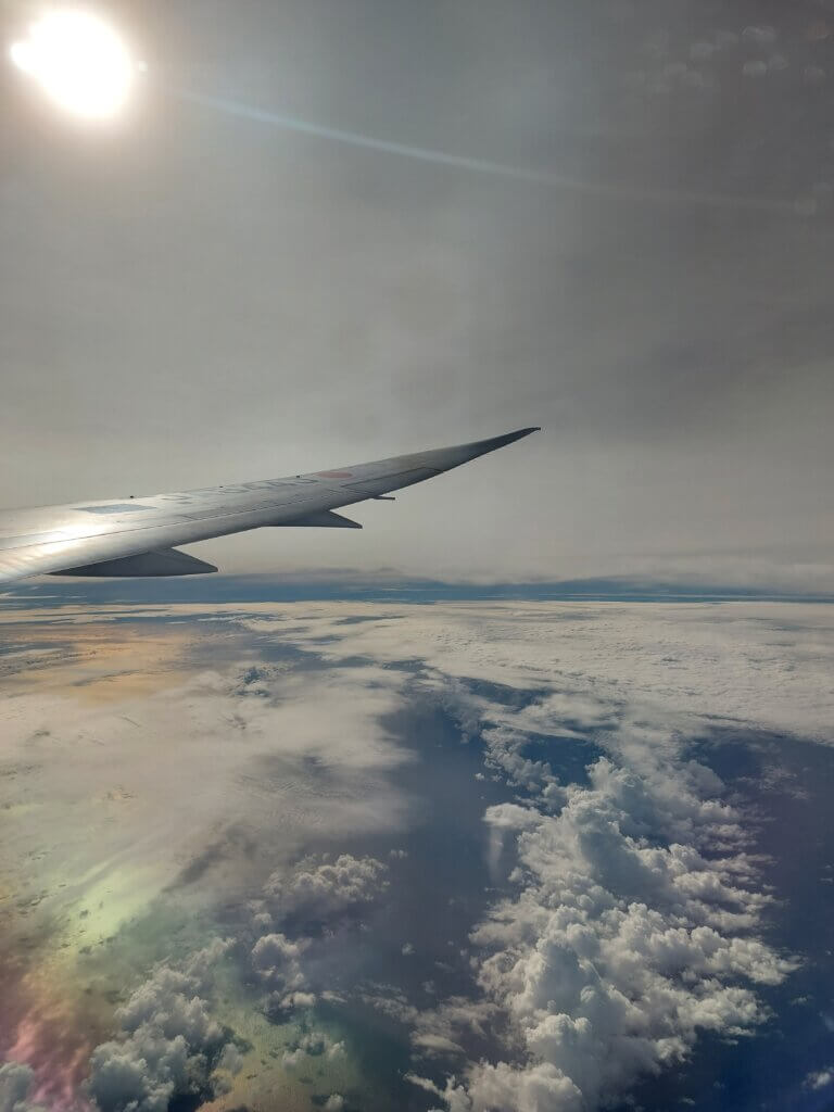 View of clouds and an airplane wing from a plane window