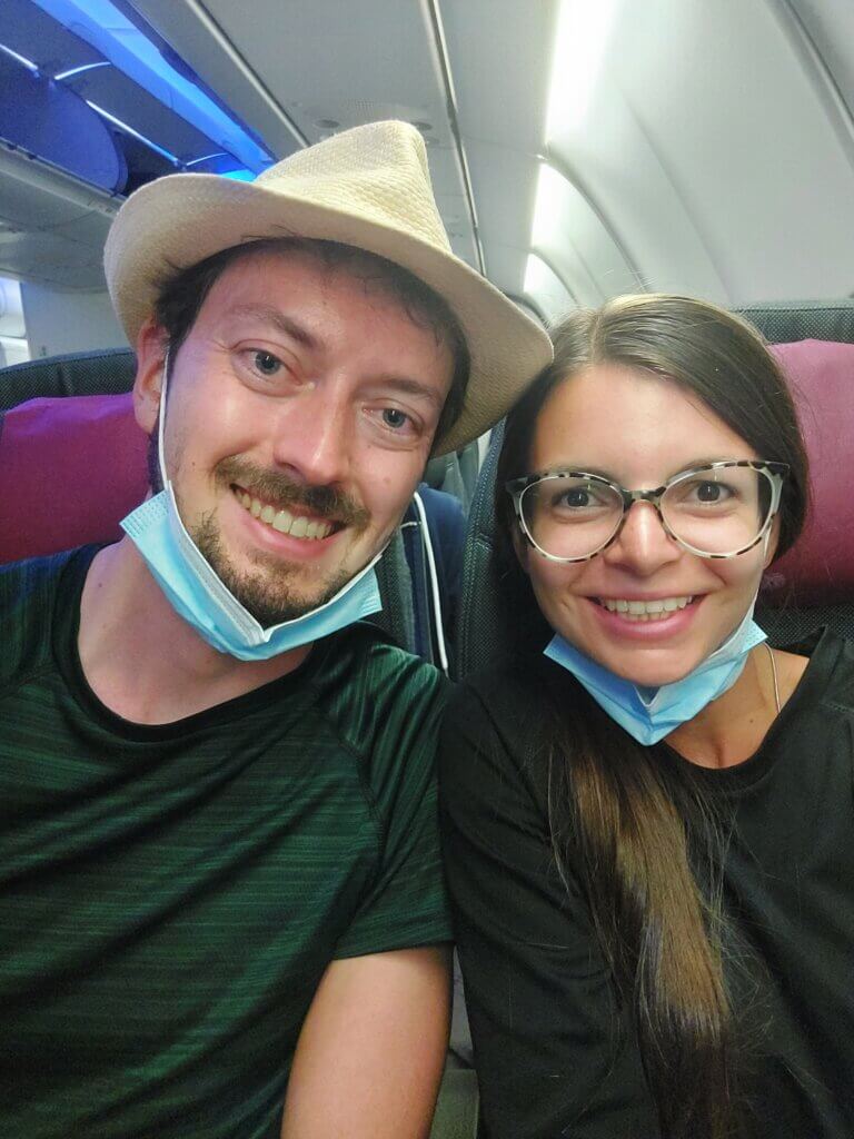 Mirka and Daniel taking a selfie on plane with face masks pulled down