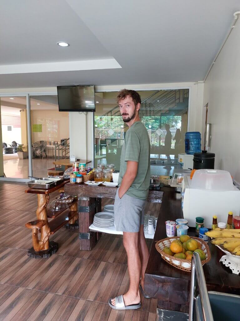 Daniel standing at the breakfast area of our accommodation during Songkran