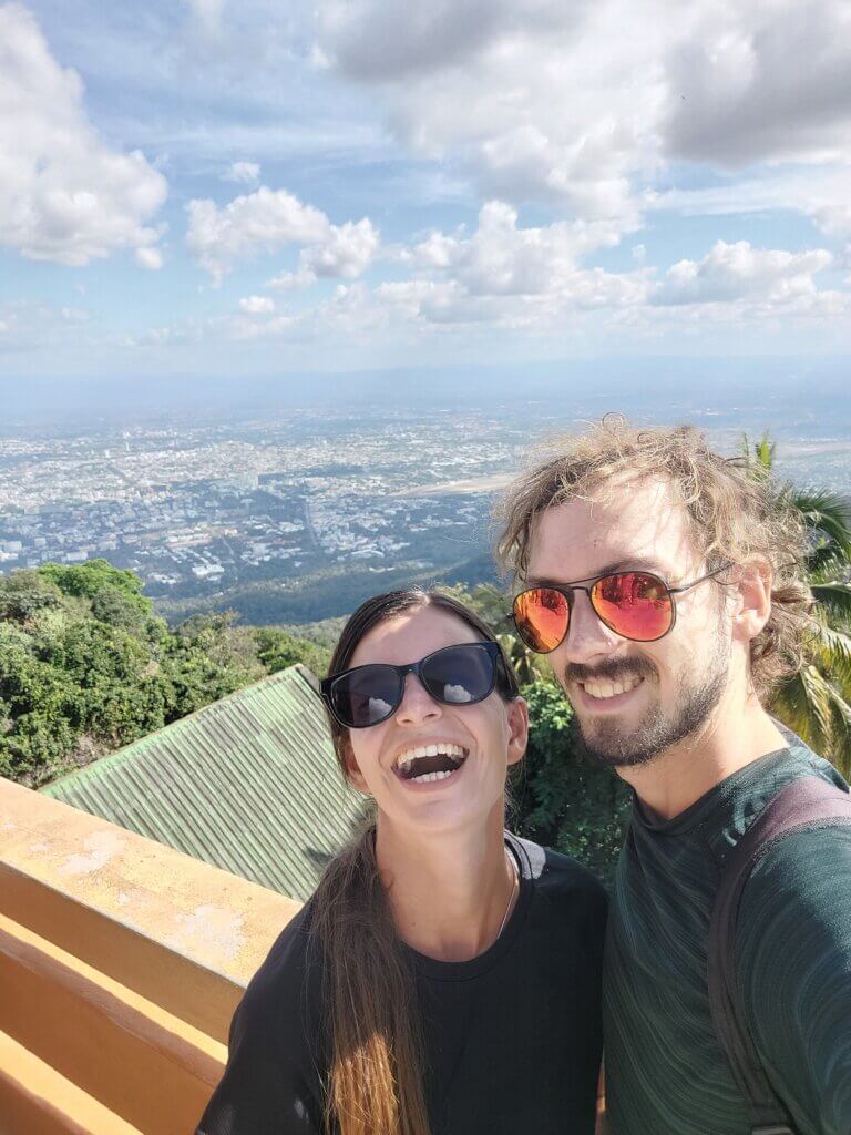 Mirka and Daniel laughing while taking a selfie at a viewpoint
