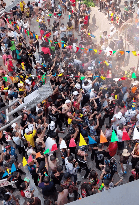A crowd of people celebrating Songkran - a photo taken from up above