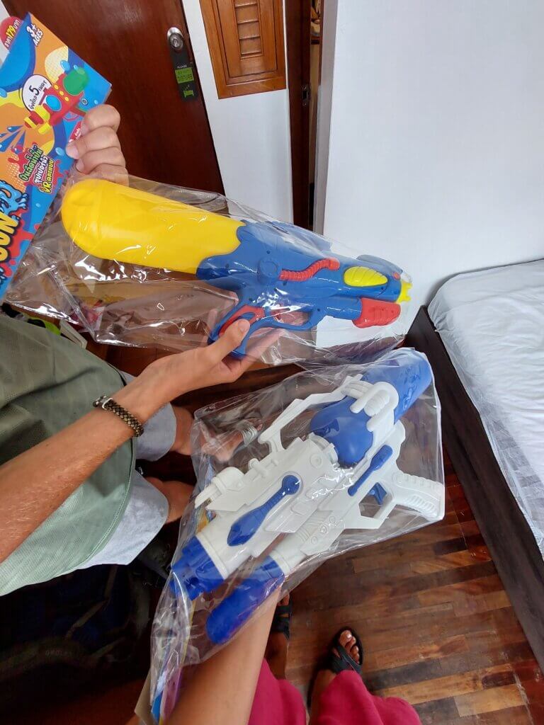 two brand new water guns in plastic packaging