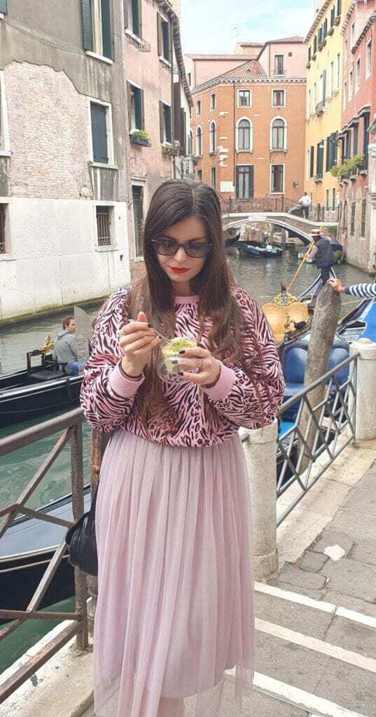 Mirka looking down at a tub of pistachio tiramisu