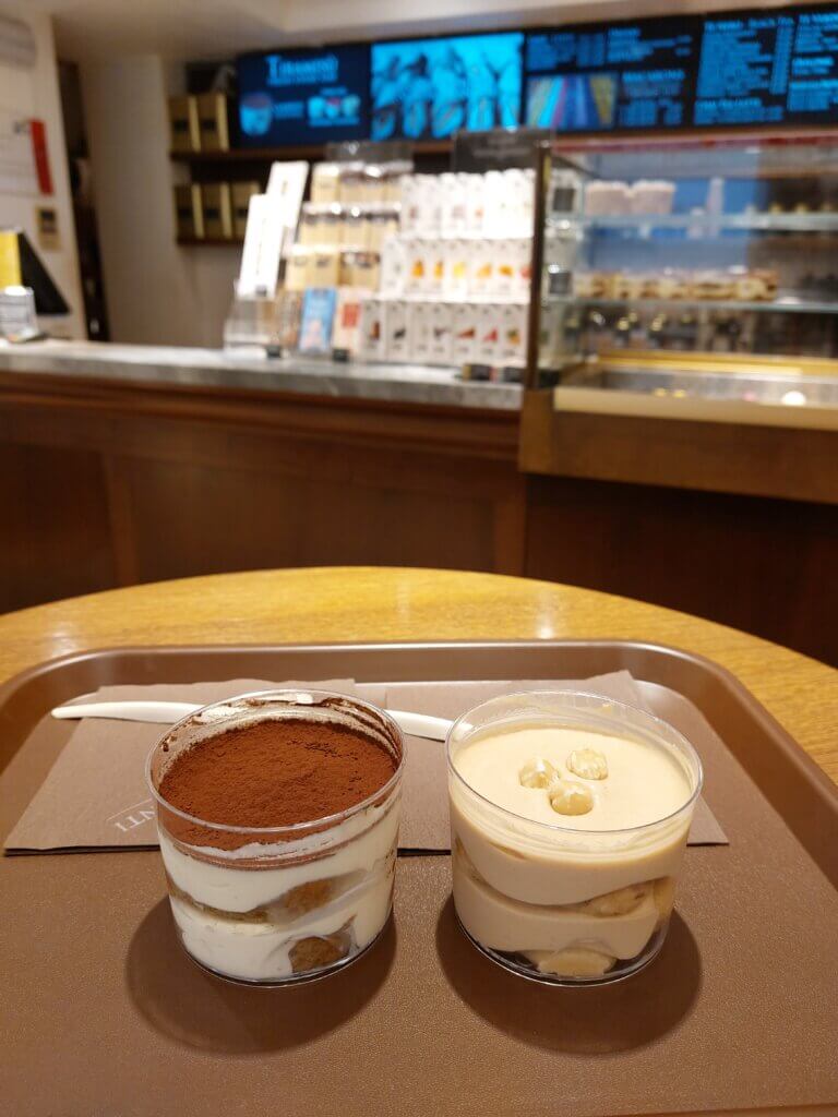 The best tiramisu in Venice - two tubs of tiramisu on a table