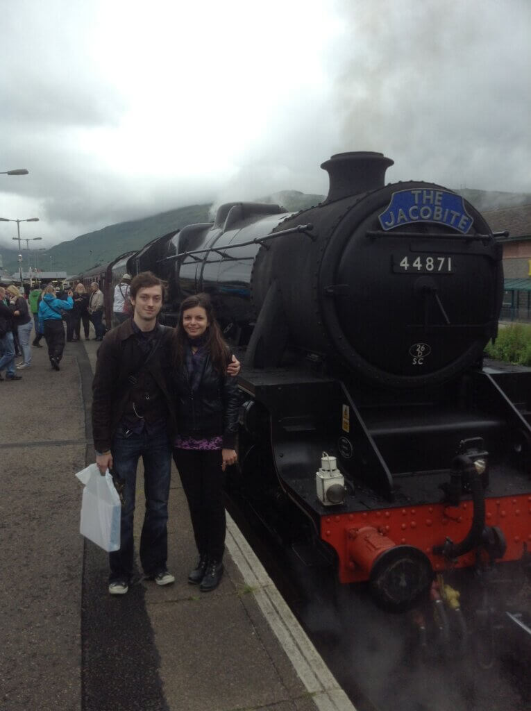 Mirka and Daniel standing next to The Jacobite train