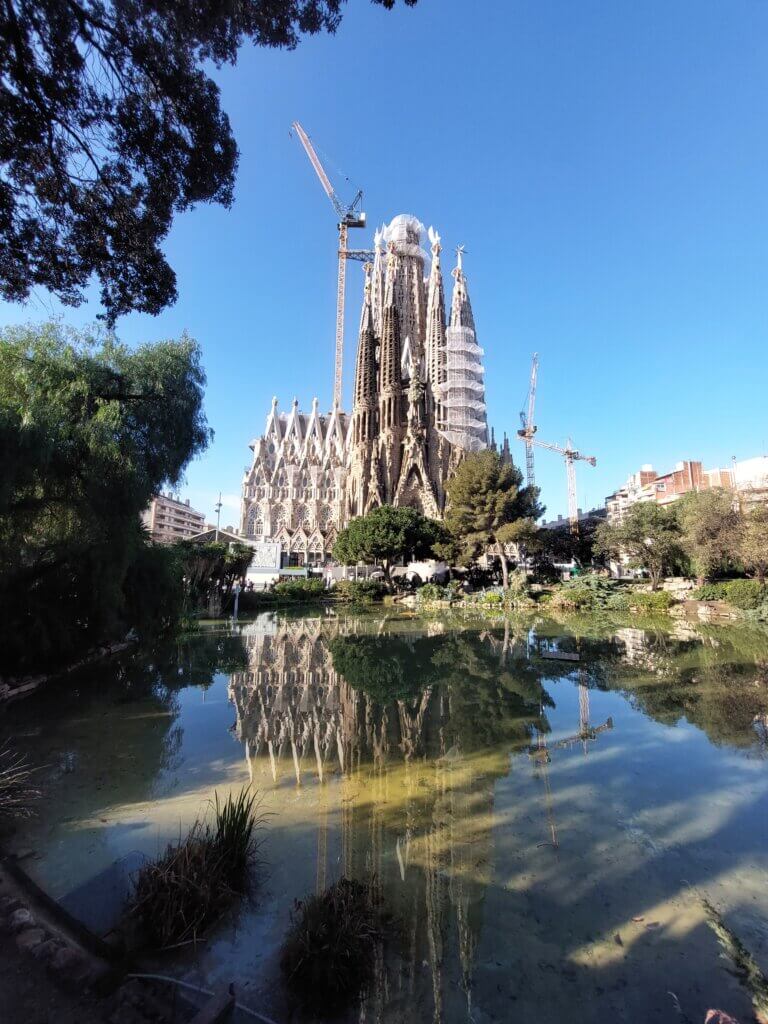 A view across the pond of Sagrada Familia and its reflection in the water