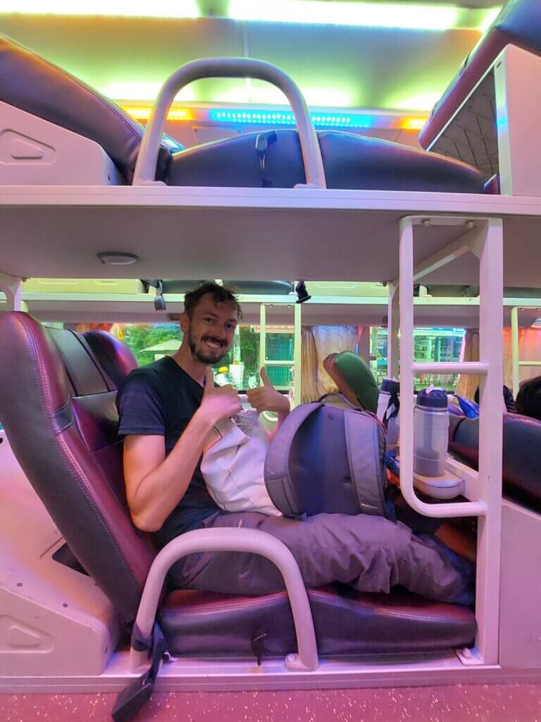 Daniel sitting on an overnight bus in Vietnam