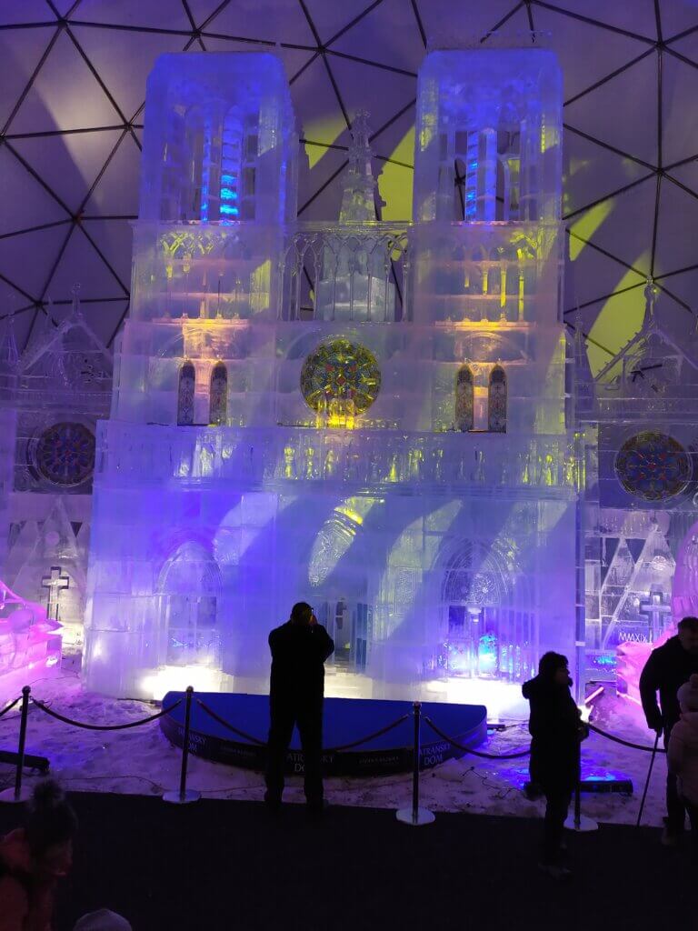 A giant dome with a massive ice sculpture of Notre Dame inside