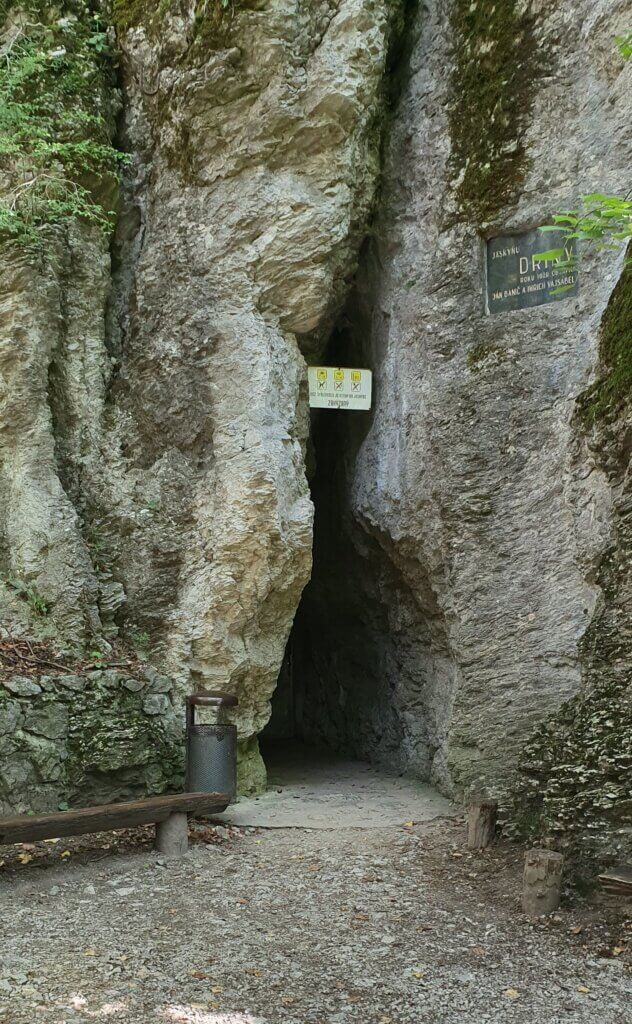 A black hole in a rocky wall - the entrance to a cave