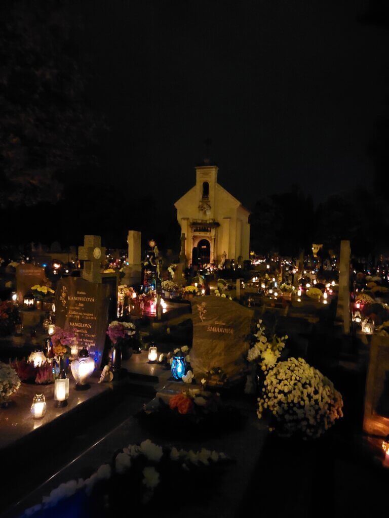 Cemetery at night with many candles lit up
