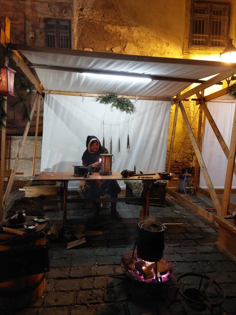 medieval candle-maker stall at a market