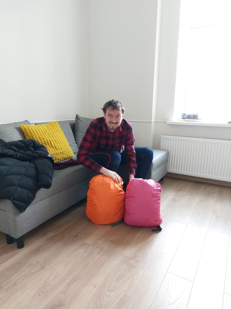Daypacks with orange and pink rain covers