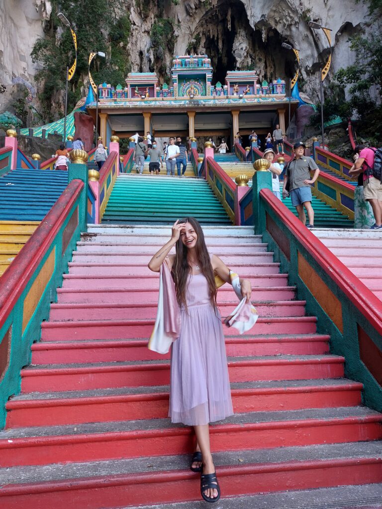 Mirka wearing a pink top and a pink skirt at the Batu Caves