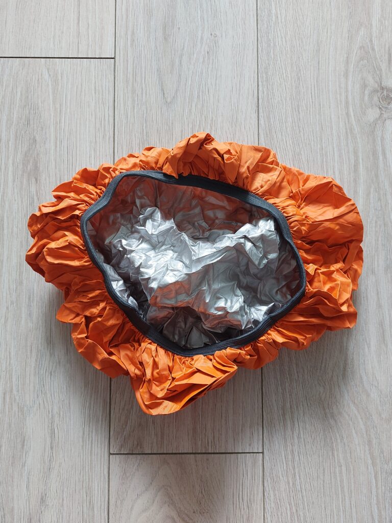 An orange waterproof backpack cover