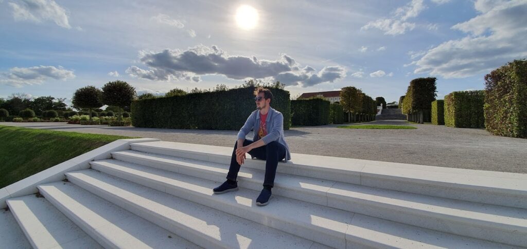 Daniel sitting on stairs in the Schloss Hof garden