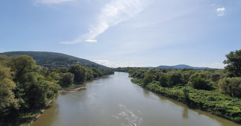 A river with green hills around it