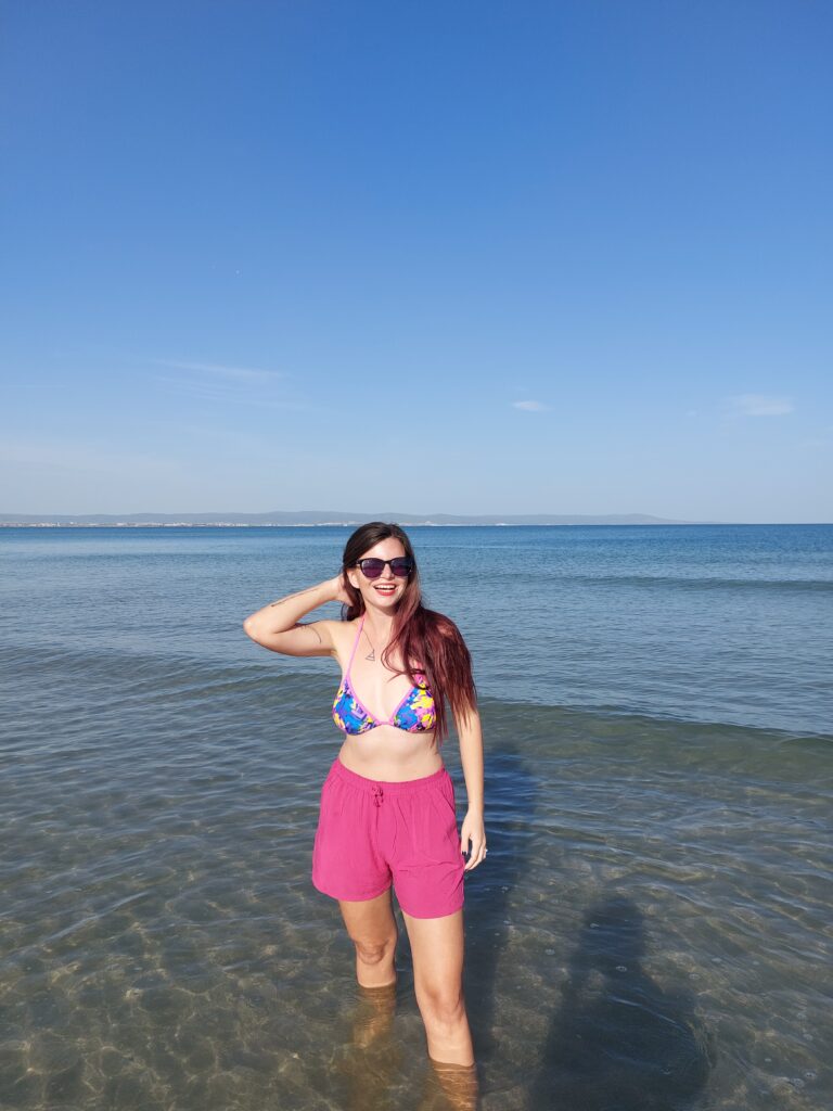 Mirka standing in shallow sea