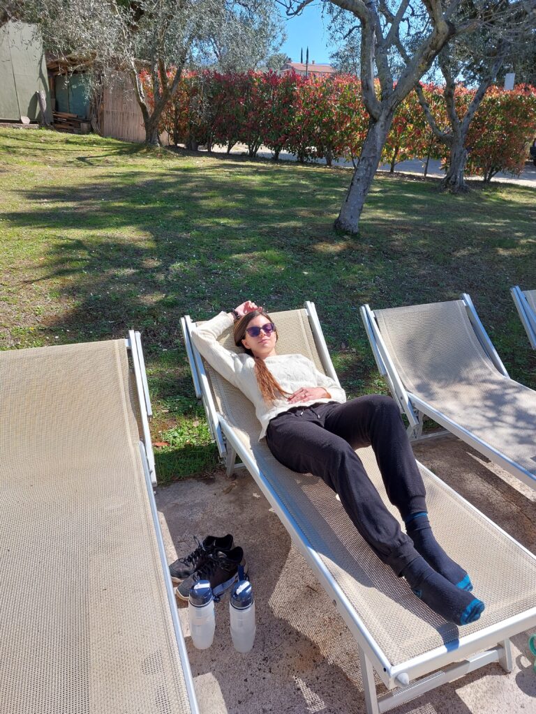 Mirka lying on a sun lounger in a garden
