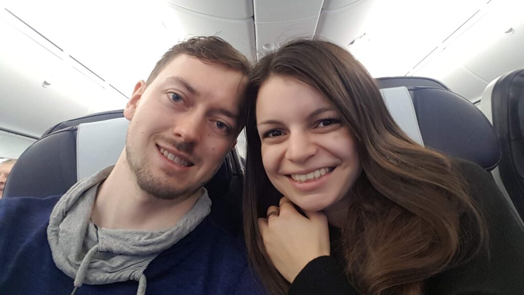 Mirka and Daniel taking a selfie on a plane