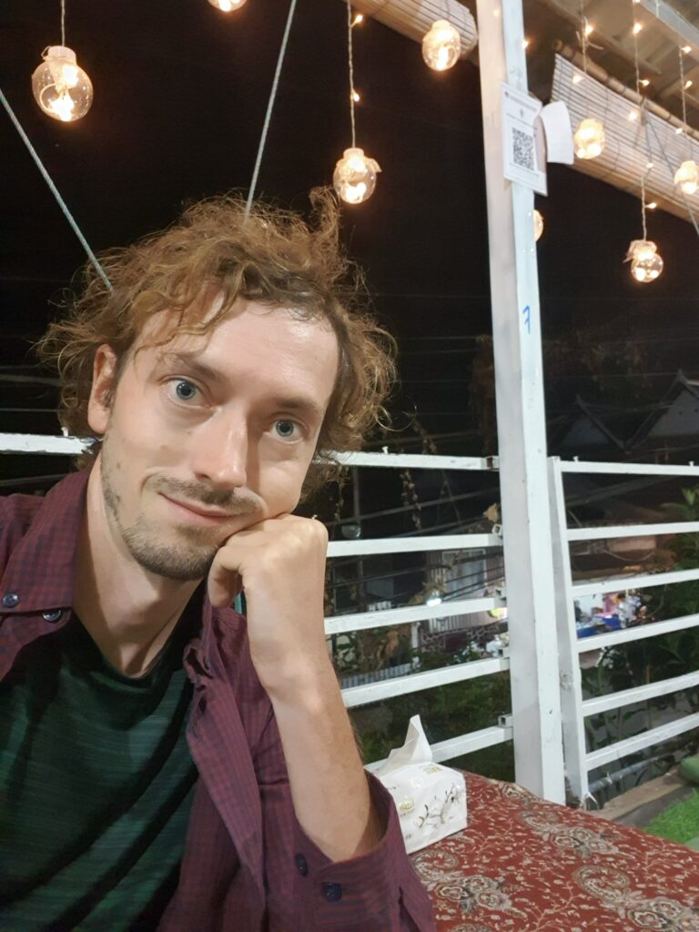 Daniel taking a selfie in a restaurant
