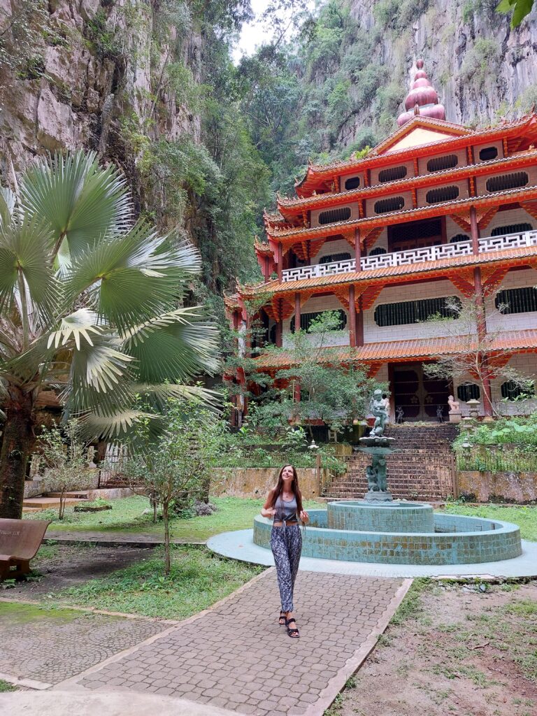 Mirka posing in front of a temple and a fountain