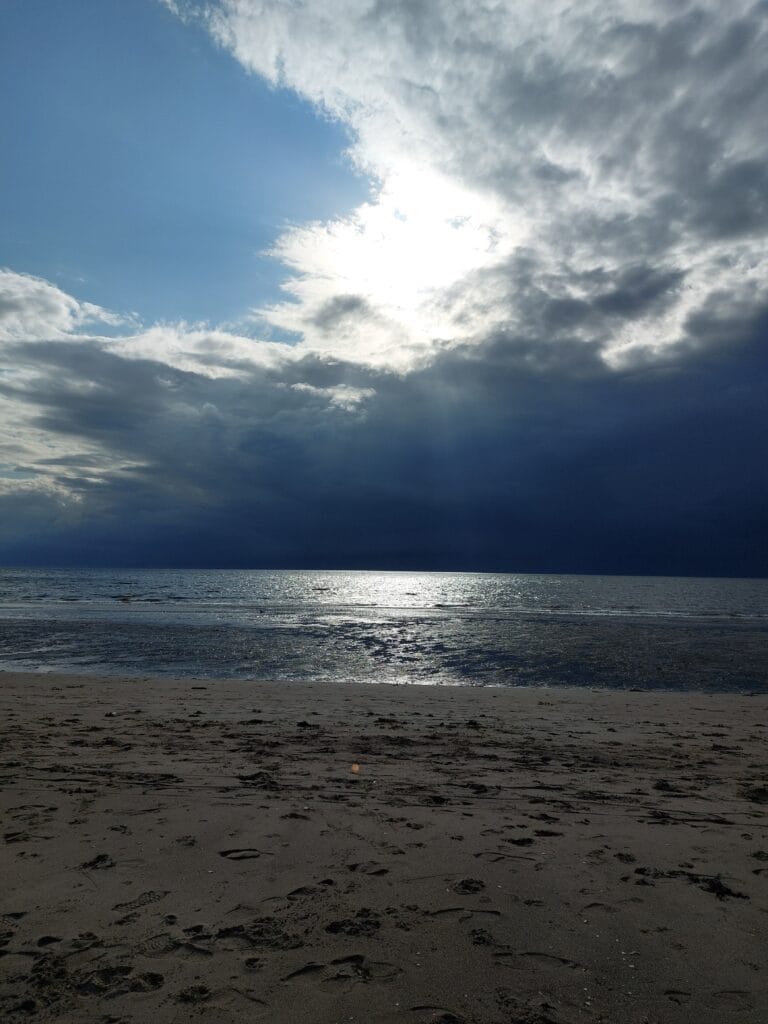 Dark clouds above the sea and beach in Scotland