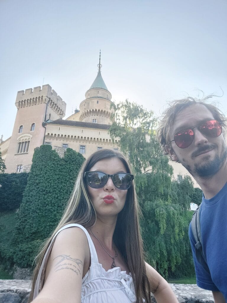Mirka and Daniel taking a selfie in front of a castle