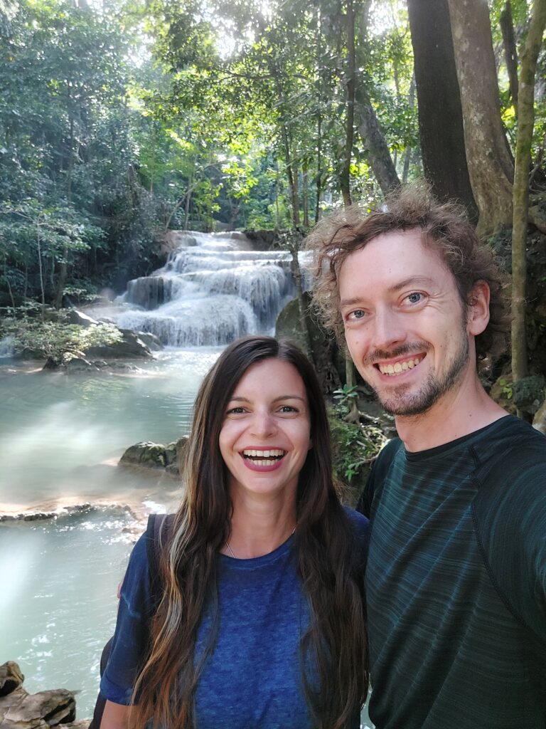 Mirka and Daniel taking a selfie in front of a waterfall