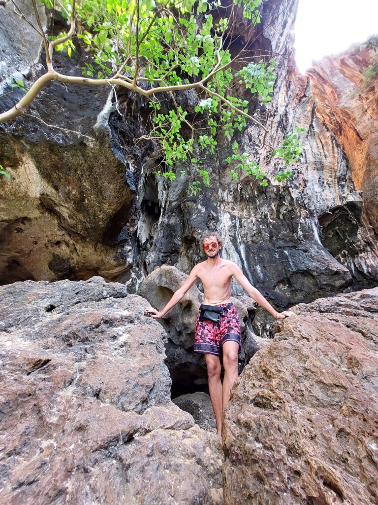 Daniel posing on rocks with a waterproof bag around his waist