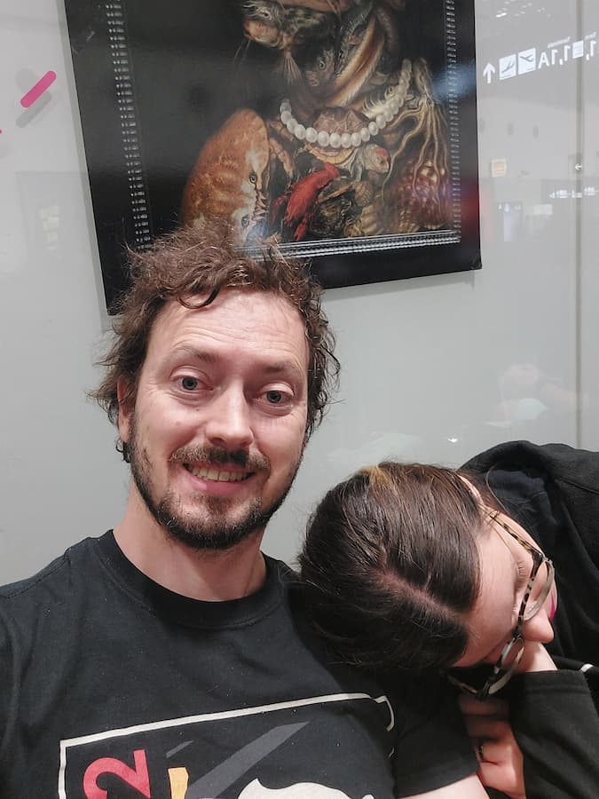 Mirka sleeping on Daniel's shoulder at an airport