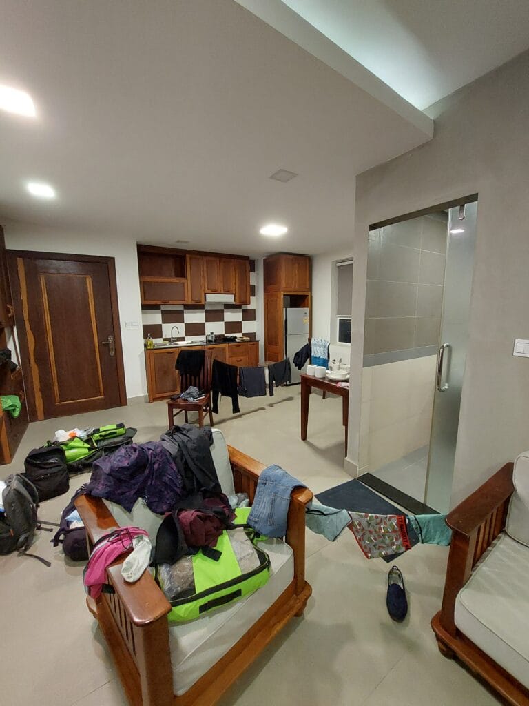 Messy apartment with clothes strung up on paracords