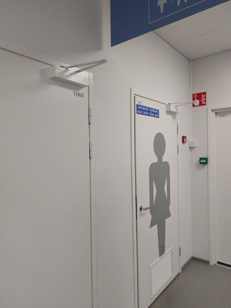 Free Water at Airports: Never Overpay for Water Again 7 Ladies bathroom door with a "water bottle filling point" sign on it