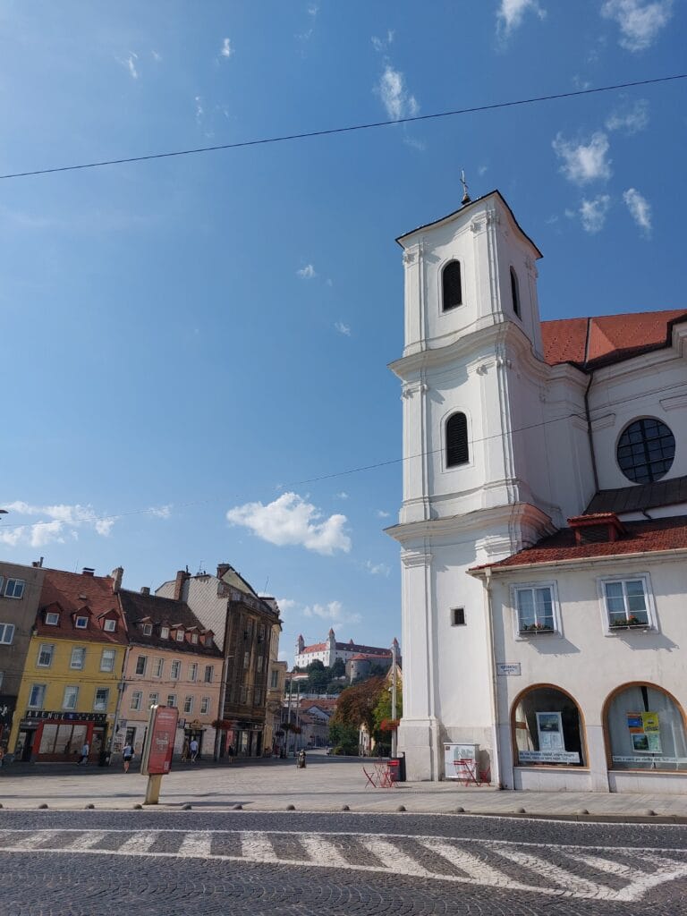 Is Bratislava Worth Visiting? The Truth + Better Alternatives 4 A street in Bratislava with the castle in the background
