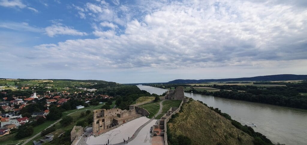 Is Bratislava Worth Visiting? The Truth + Better Alternatives 6 View of castle ruins, a river and a village