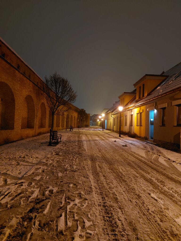 A snowy street during evening