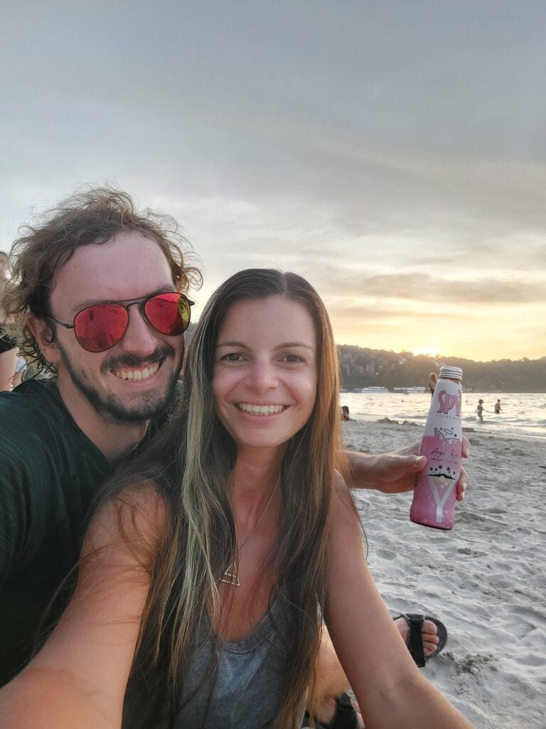 Mirka and Daniel taking a selfie at the beach with sunset