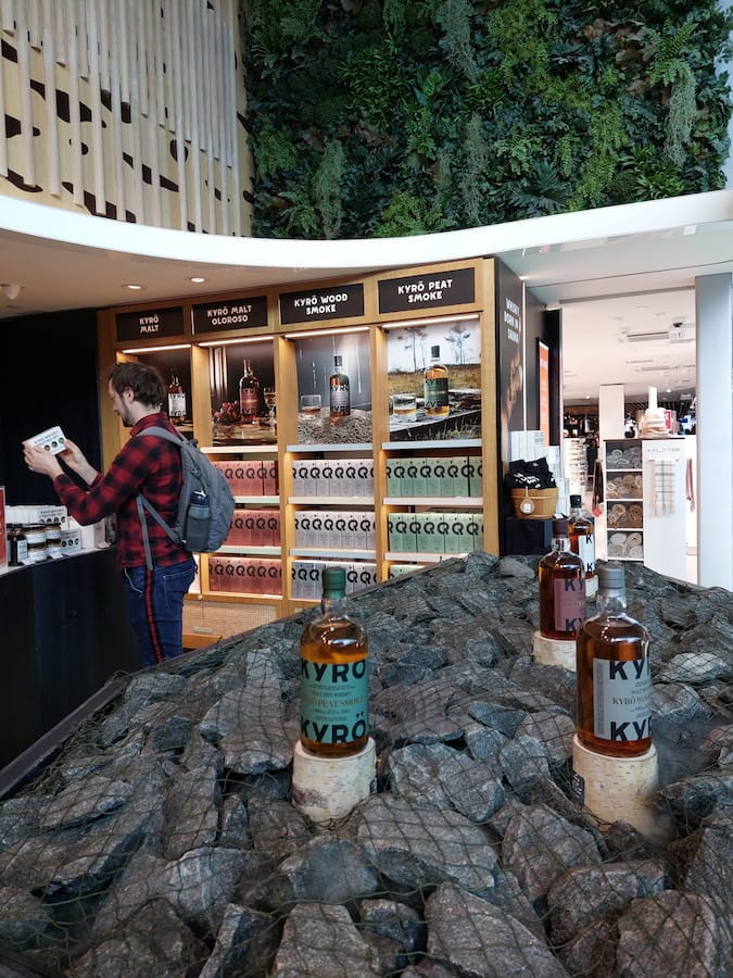 Daniel picking up a box of Kyrö whisky at an airport