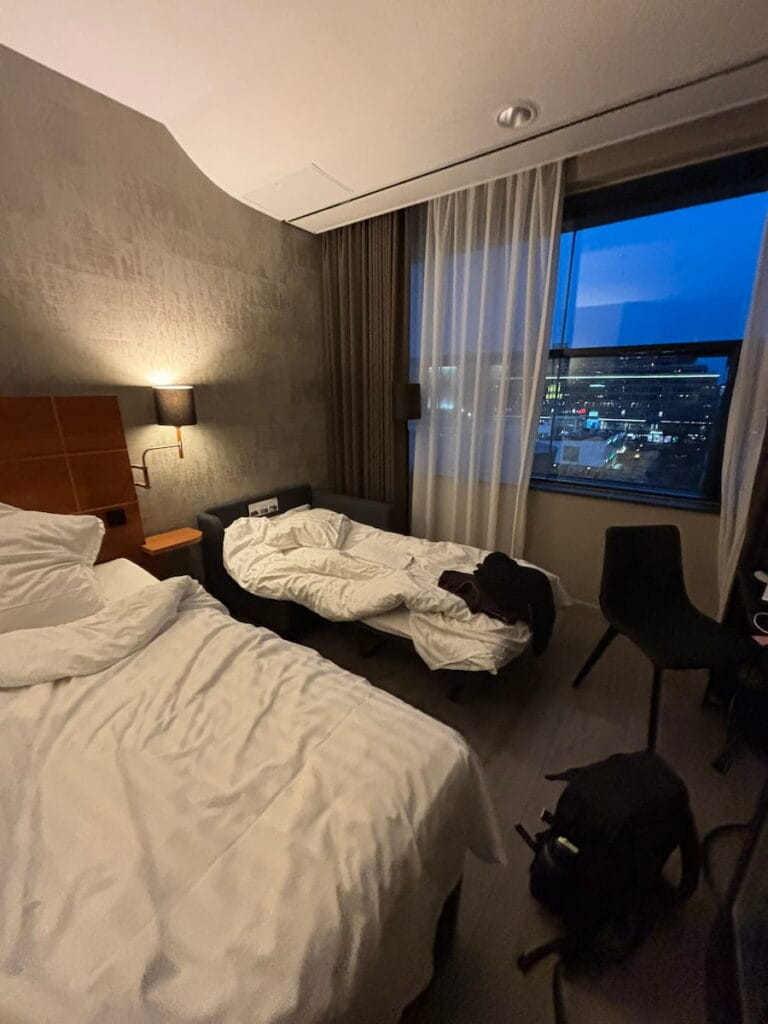 A double bed and a sofa bed in a hotel room