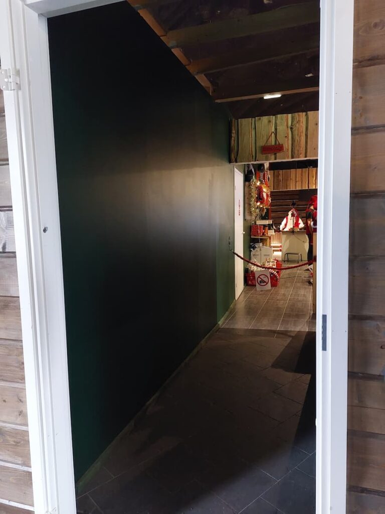 Fake Santa with a camera on a tripod and a no photo sign