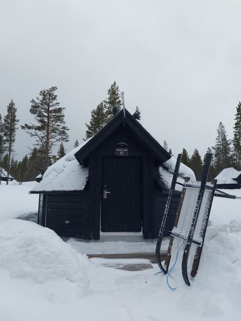 Wooden cabin with a sled in front of it