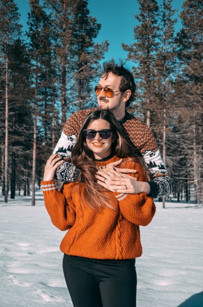 Mirka and Daniel posing in the snow with wedding bands
