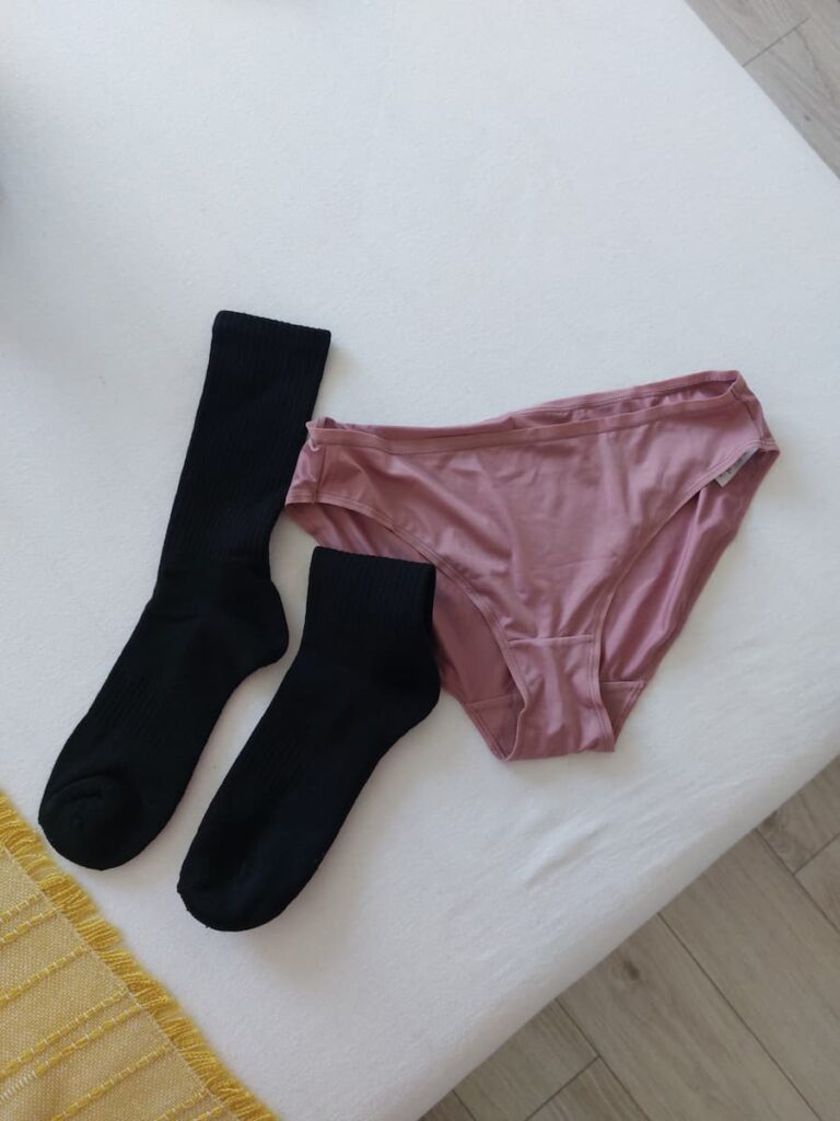 A pair of socks and knickers on a bed