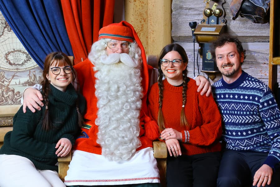 Mirka, Daniel and Mirka's sister posing with the real Santa Claus in Finland